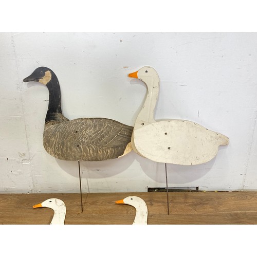 393 - A Johnson's printed card folding Canada Goose Decoy and three similar Snow Goose Decoys with three m... 