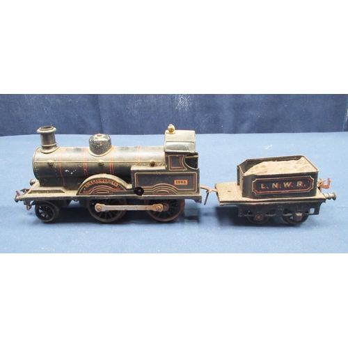 40 - A Bassett-Lowke clockwork 0 gauge King Edward VII Locomotive and tender, three four wheel Coaches in... 