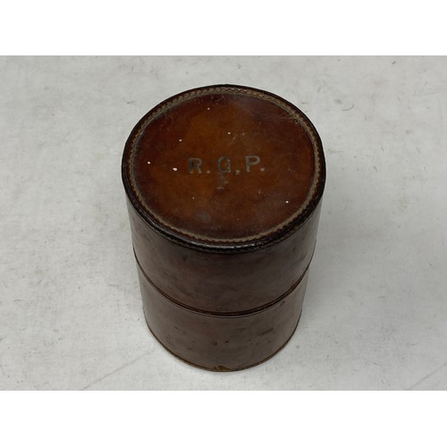 396 - A set of six plated graduated Beakers in fitted leather case bearing initials R.G.P. 5 1/2in