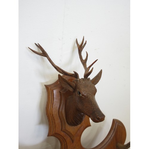 400C - A Black Forest style oak shield shaped Whip Rack with antler tines and carved deer head 3ft 1in H x ... 