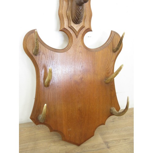 400C - A Black Forest style oak shield shaped Whip Rack with antler tines and carved deer head 3ft 1in H x ... 