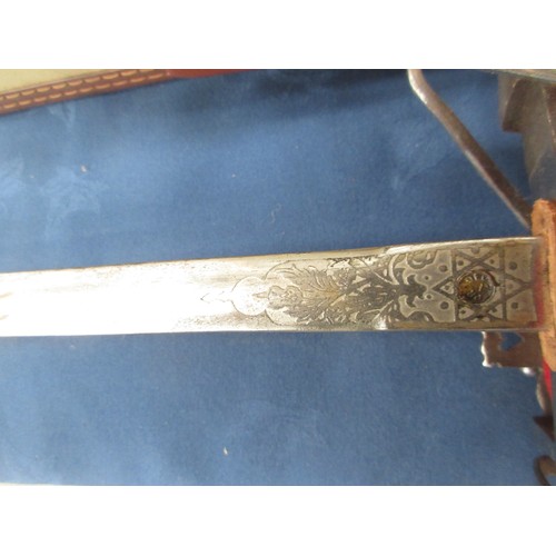 264 - A basket hilted Sword in steel scabbard, a wooden handled Sabre with brass hilt and metal scabbard, ... 