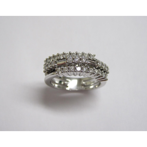 165 - A Diamond half Eternity Ring having three offset rows of peg-set brilliant-cut stones in 18ct white ... 