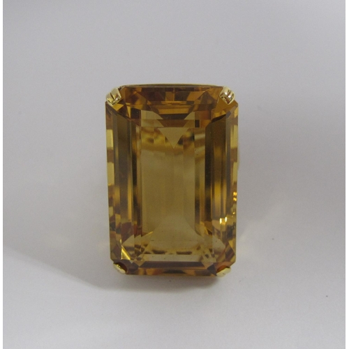 168 - A large Citrine Ring corner claw-set step-cut stone, 44.70cts in pierced 18ct gold mount, ring size ... 