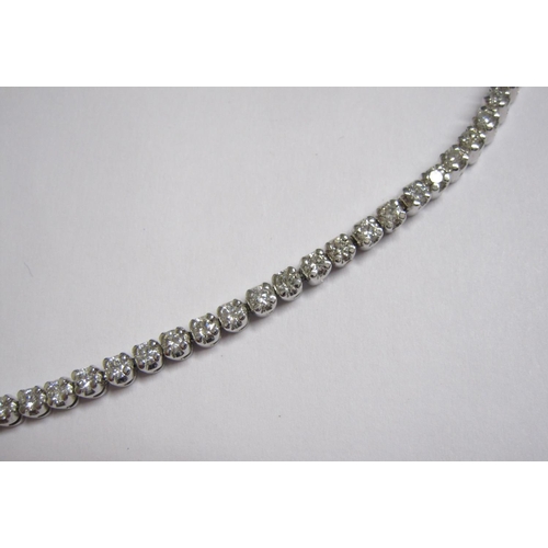 170 - A Diamond Tennis Bracelet having fifty four flexible links each claw-set brilliant-cut stone on hidd... 