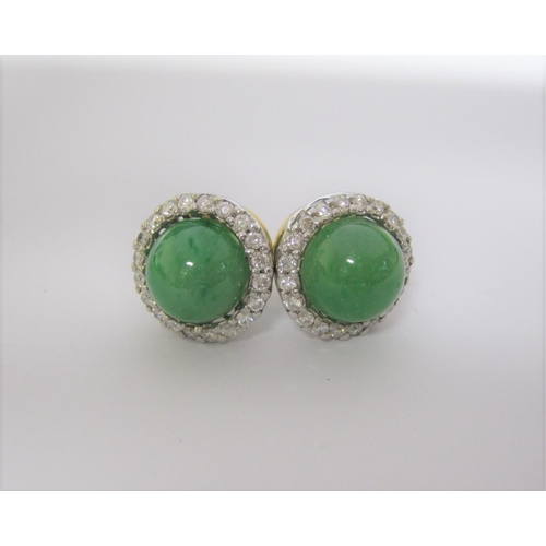 174 - A pair of Jade and Diamond Cluster Earrings each set round jade cabochon within a frame of brilliant... 