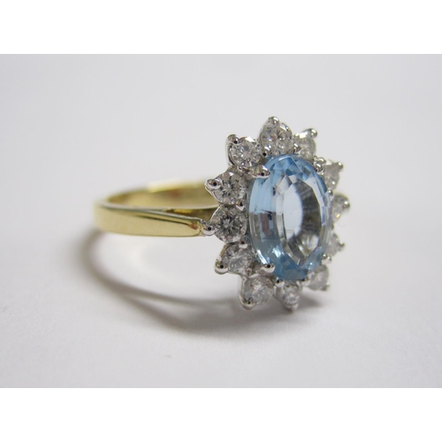 185 - An Aquamarine and Diamond Cluster Ring claw-set oval-cut aquamarine, 0.90cts, within a frame of twel... 