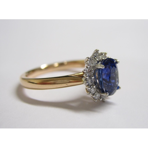 193 - A Sapphire and Diamond Cluster Ring claw-set oval-cut sapphire, 1.25cts, within a frame of brilliant... 