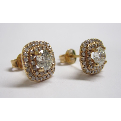 194 - A pair of Diamond Cluster Earrings each claw-set brilliant-cut stone within a double frame of smalle... 