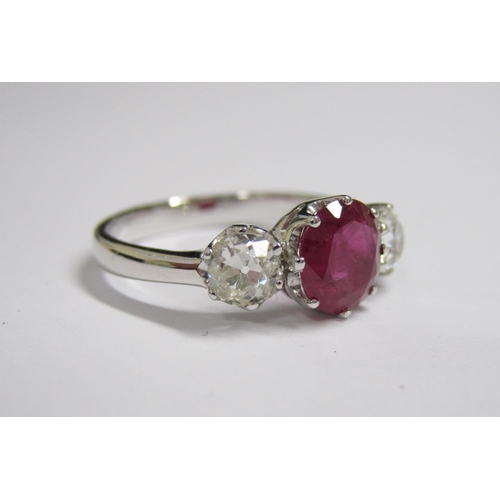 199 - A Ruby and Diamond three stone Ring claw-set round ruby, 1.45cts, between two old-cut diamonds in pl... 