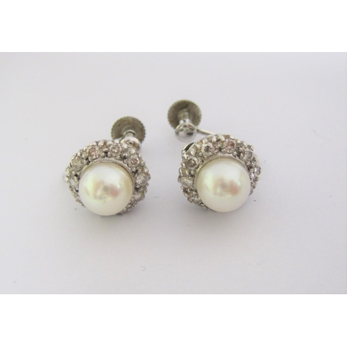 205 - A pair of cultured Pearl and Diamond Earrings each set pearl within a frame of brilliant-cut diamond... 