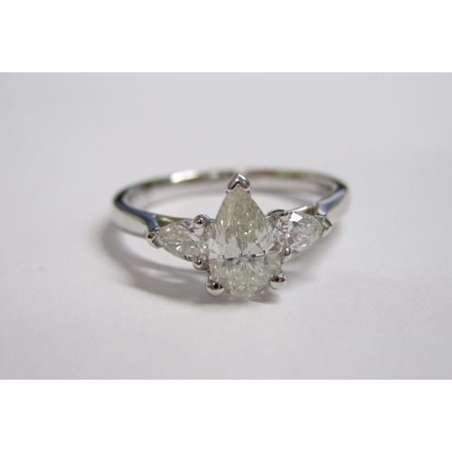 214 - A Diamond three stone Ring claw-set pear-cut stone, 0.70cts between two smaller pear-cut stones in 1... 