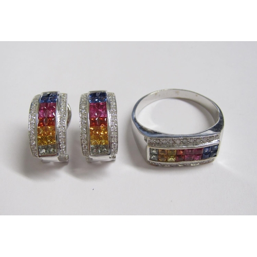 215 - A Fancy Sapphire Ring channel-set, a double row of princess-cut sapphires in rainbow of colours betw... 