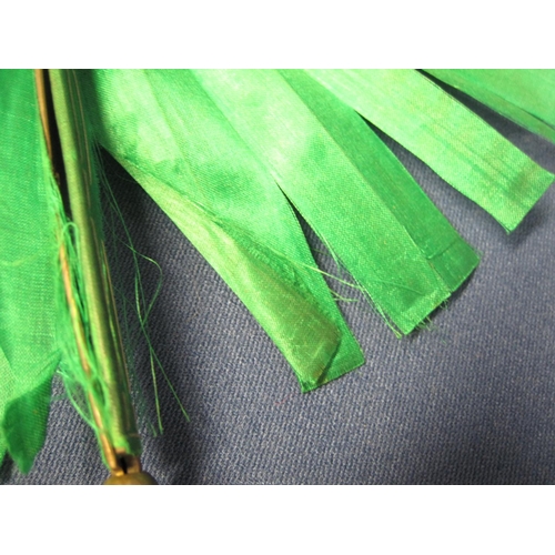 231 - A brass cased Cockade Fan with green watermarked silk leaf A/F, case bearing Royal Warrant, marked '... 