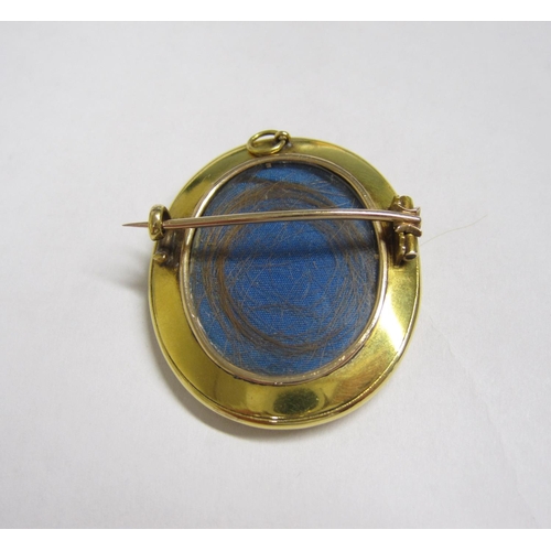 233 - An oval Locket/Brooch with painted miniature of child in blue dress, enclosing lock of hair verso