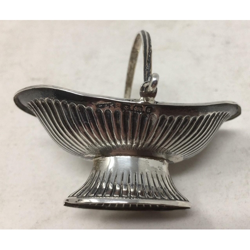 248 - An Edward VII silver miniature toy Cake Basket of oval fluted form with swing handles, Birmingham 19... 