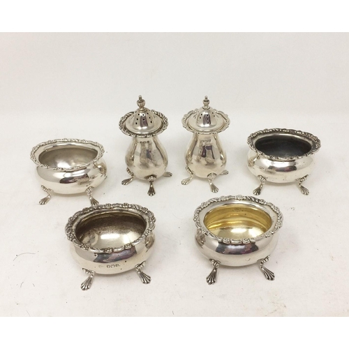 262 - Four George V silver oval Salts and two Pepperettes with floral scroll rims, Birmingham 1920, etc.