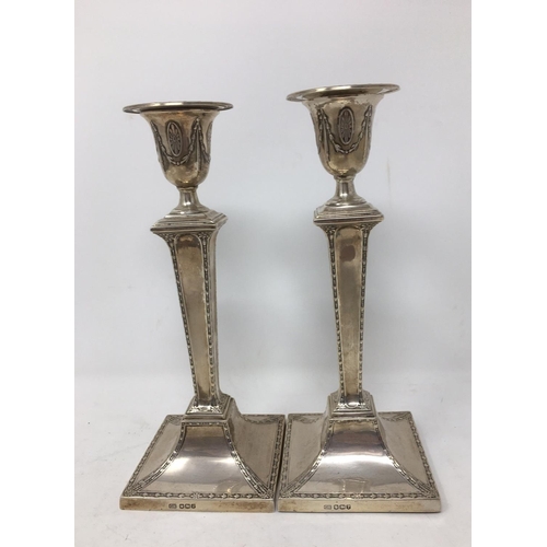 274 - A pair of George V silver Candlesticks with square tapering columns, Sheffield 1926, 8 1/2 in, drill... 