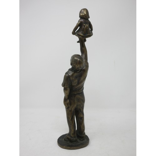 380 - A bronze Figure of a man holding a child above his head, 12 1/2in H