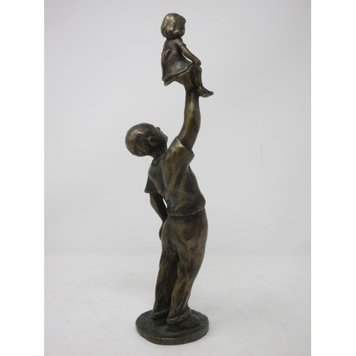 380 - A bronze Figure of a man holding a child above his head, 12 1/2in H