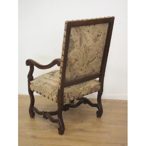 127 - A large carved Elbow Chair with tapestry back and seat on shaped and scrolled supports