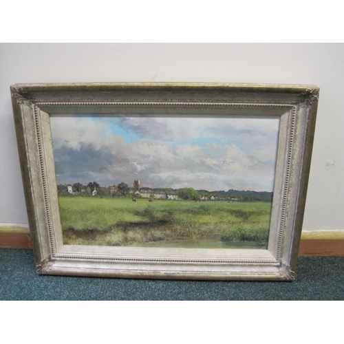 341 - CLIVE MADGWICK RBA. View across a meadow towards a village, signed, oil on canvas, 11 1/2 x 17 in.