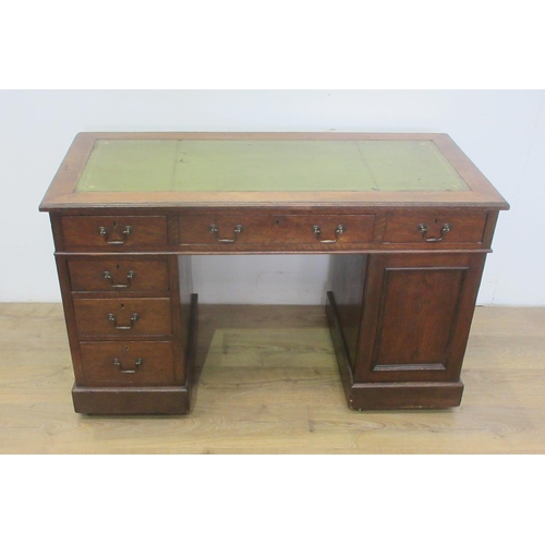 387 - An Edwardian oak Desk with leather inset writing surface fitted cupboard and six drawers mounted upo... 