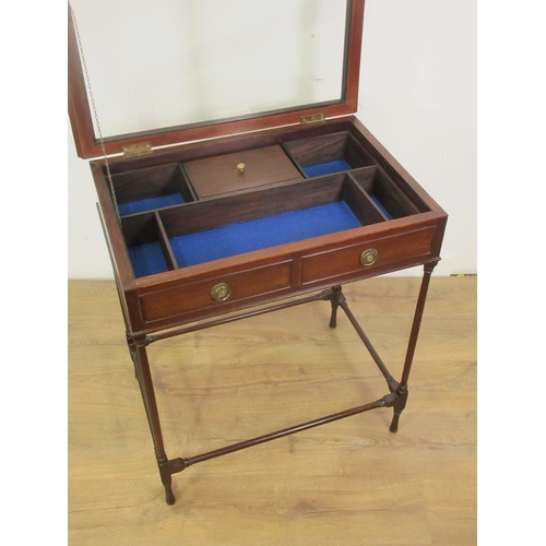 393 - A mahogany Table Display Cabinet with hinged glass lid enclosing a divided interior mounted upon tur... 