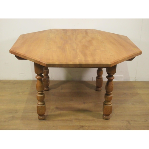 58 - An elm octagonal Dining Table, with baluster turned supports, 4ft 2in