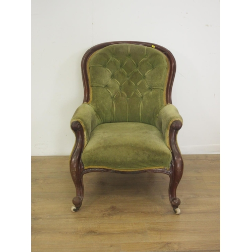 85 - A Victorian mahogany button upholstered Armchair on casters.