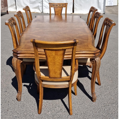 91 - A reproduction burr oak extending Dining Table and eight matching Dining Chairs, the table with shap... 