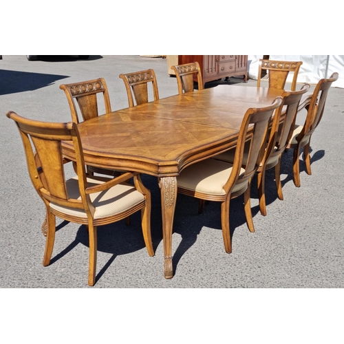 91 - A reproduction burr oak extending Dining Table and eight matching Dining Chairs, the table with shap... 