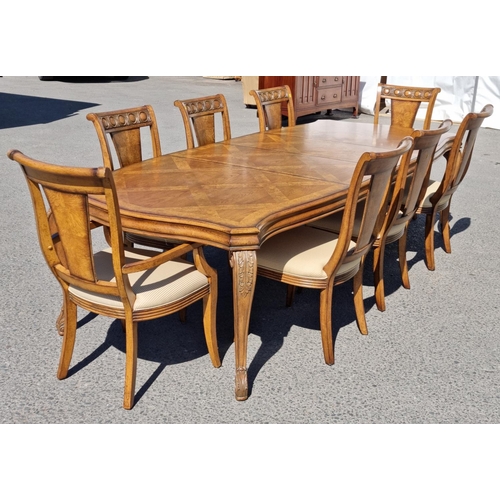 91 - A reproduction burr oak extending Dining Table and eight matching Dining Chairs, the table with shap... 