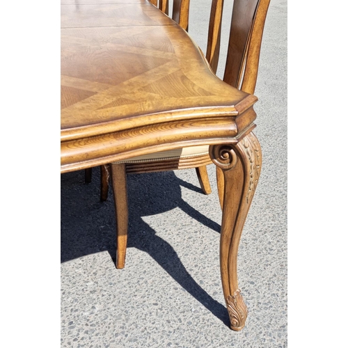 91 - A reproduction burr oak extending Dining Table and eight matching Dining Chairs, the table with shap... 