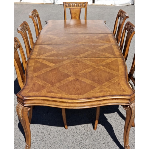 91 - A reproduction burr oak extending Dining Table and eight matching Dining Chairs, the table with shap... 