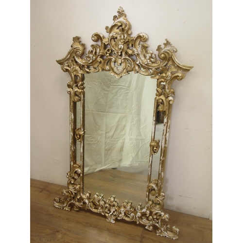 659 - A reproduction gilt framed Wall Mirror with scroll and leafage design 4ft 6in H x 2ft 8in W