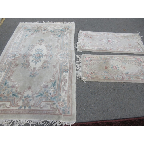 664 - A Chinese pink ground Rug 8ft 2in x 4ft 11in and two smaller Rugs 4ft 6in x 2ft 4in and 4ft 3in x 2f... 