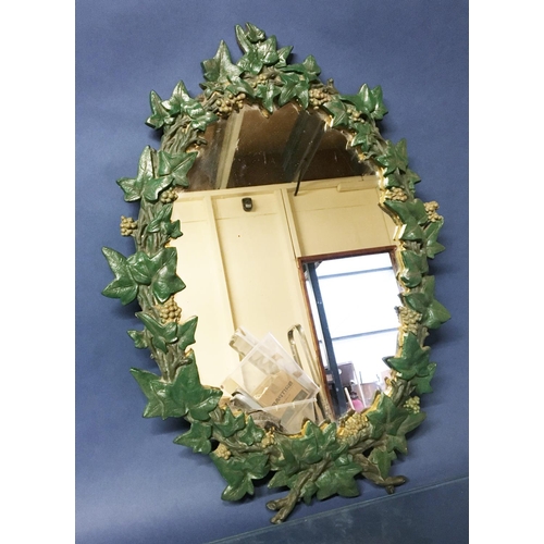 658 - An oval cast metal Coalbrookdale style framed Wall Mirror with ivy leaf and berry design 1ft 7in x 1... 