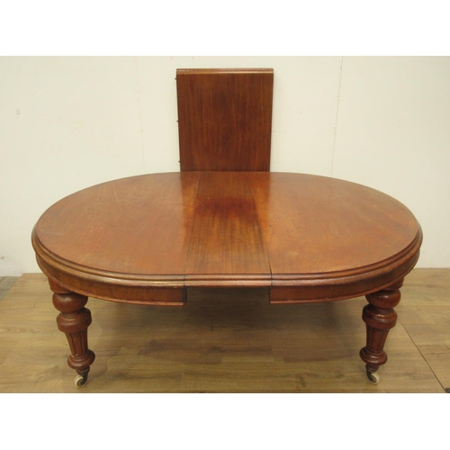 333 - A Victorian mahogany extending Dining Table on heavy turned supports with ceramic casters and two sp... 