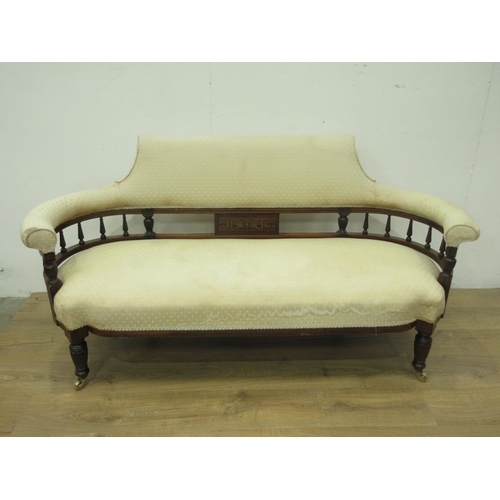 129 - A Victorian rosewood and inlaid Sofa with cream upholstery and fluted spindle back mounted upon balu... 