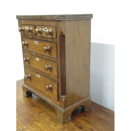 407 - A 19th Century oak Apprentice Chest of two short and three long Drawers with chamfered corners on br... 