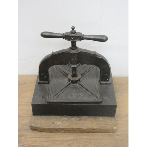 474 - A cast iron Book Press mounted on a wooden block, 14 x 11 1/2in