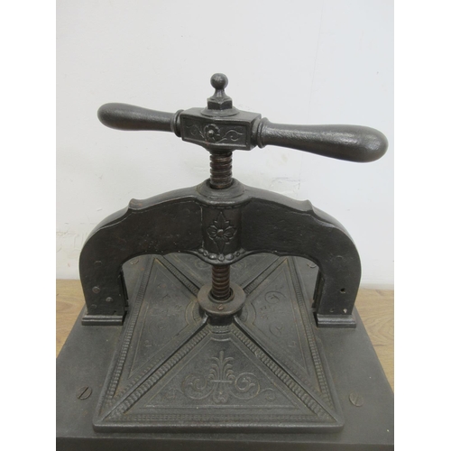 474 - A cast iron Book Press mounted on a wooden block, 14 x 11 1/2in