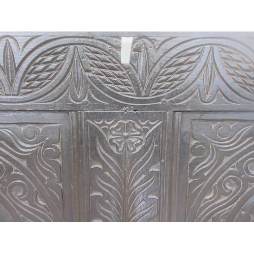 475 - An antique oak front Panel from a coffer with carved designs, 4ft W