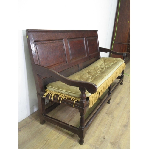 489 - An 18th Century oak Settle with three panel back mounted upon turned supports 6ft 1in W x 3ft 4in H