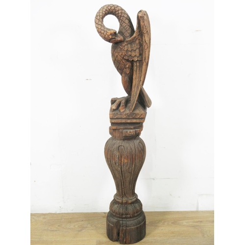 498 - An antique carved oak baluster Column 16in H and a carved Liver Bird 16in H