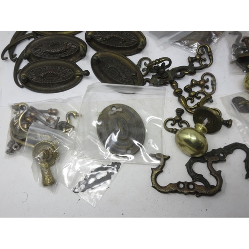 5 - A quantity of brass furniture Handles including ovals, knobs and pierced