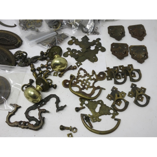 5 - A quantity of brass furniture Handles including ovals, knobs and pierced