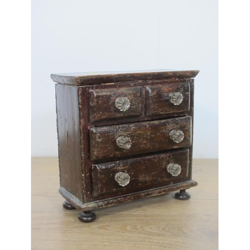 522 - A Victorian stained pine apprentice piece Chest of two short and two long drawers with glass handles... 