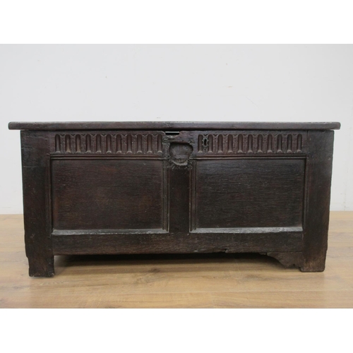 525 - A 17th Century oak Coffer with two sunken two panel lid above nulled frieze and two panel front 3ft ... 